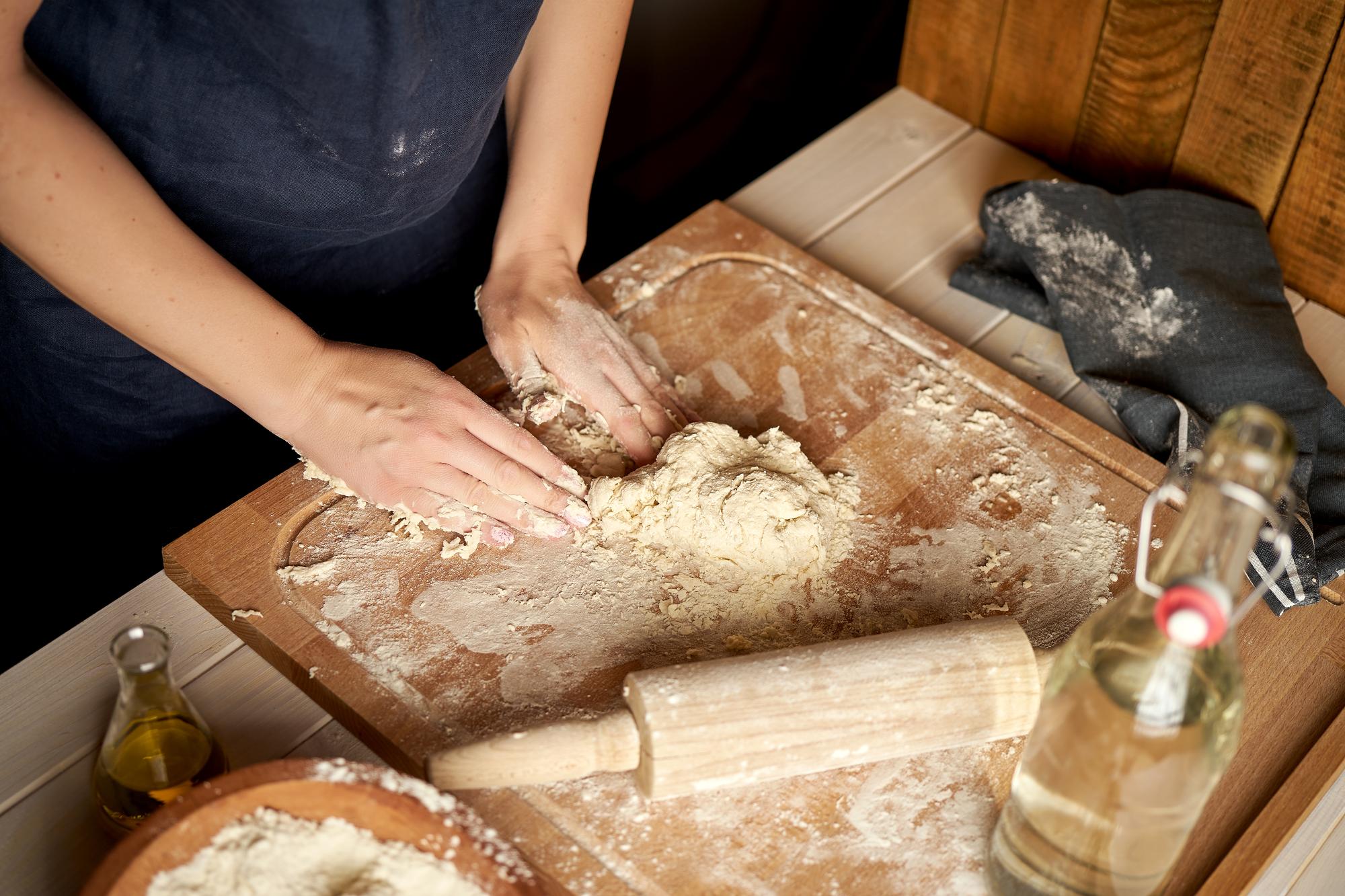 close-up of sourdough being scored before baking