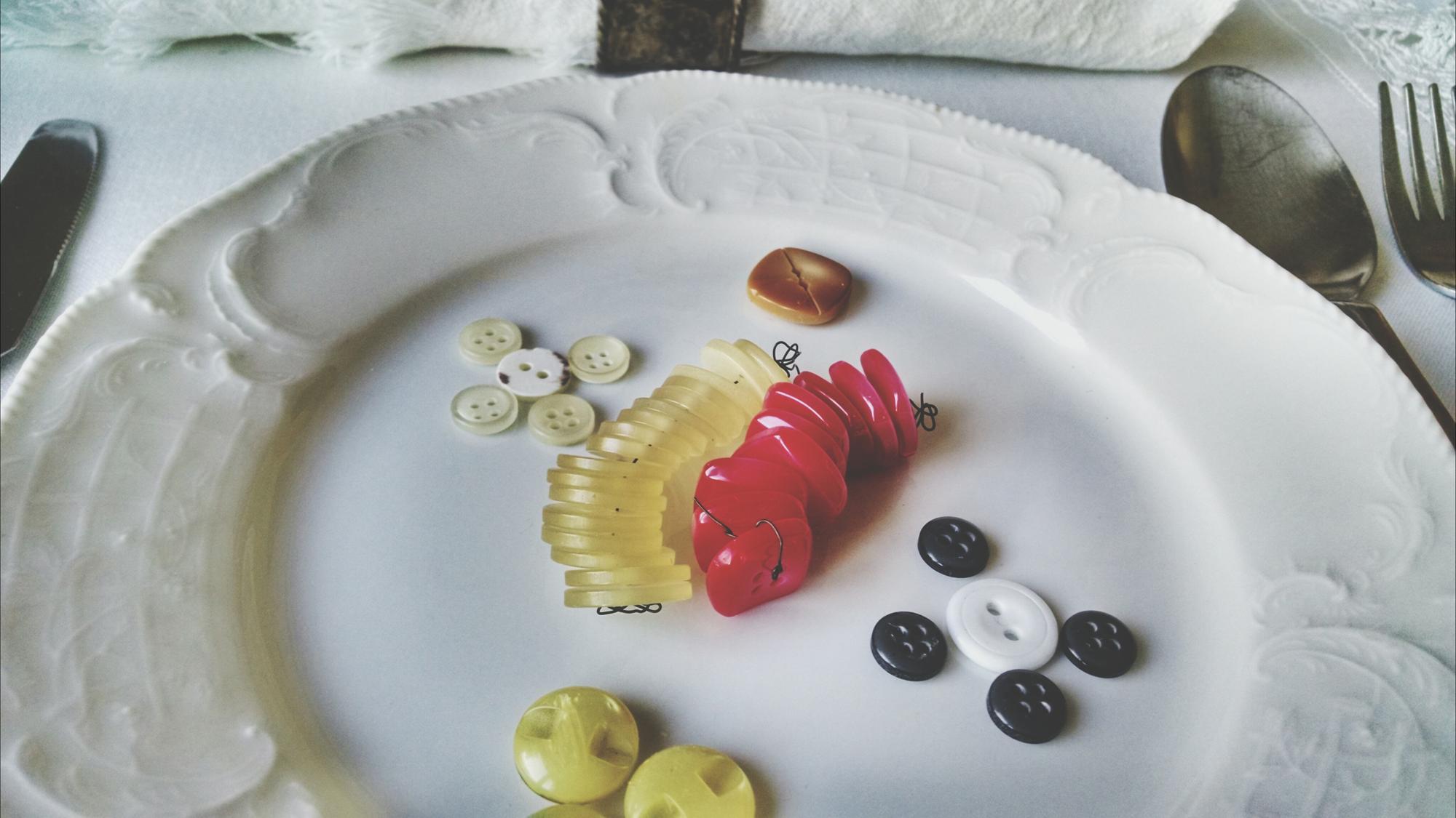 small plated tasting course with herb garnish